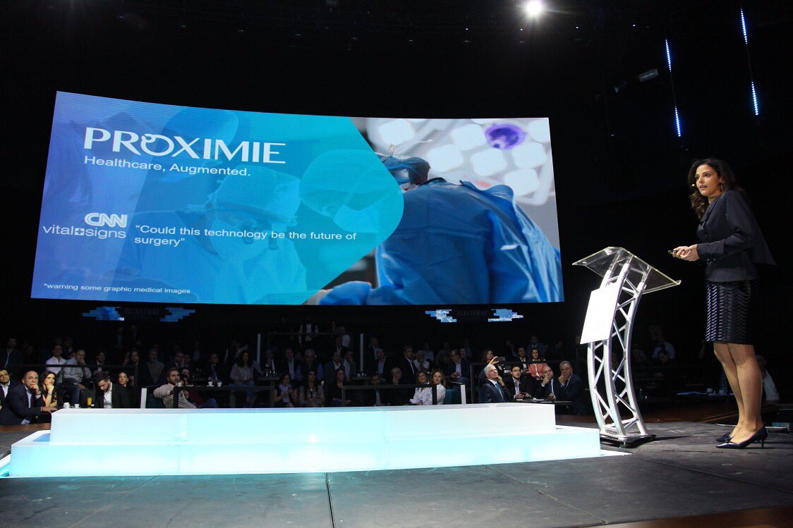angelslbnetwork's tweet photo. @DrNadz CEO of @ProximieAR takes stage to talk about her company that builds augmented reality technology that helps surgeons get remote assistance and training from anywhere around the world. https://t.co/guw1hqGKef