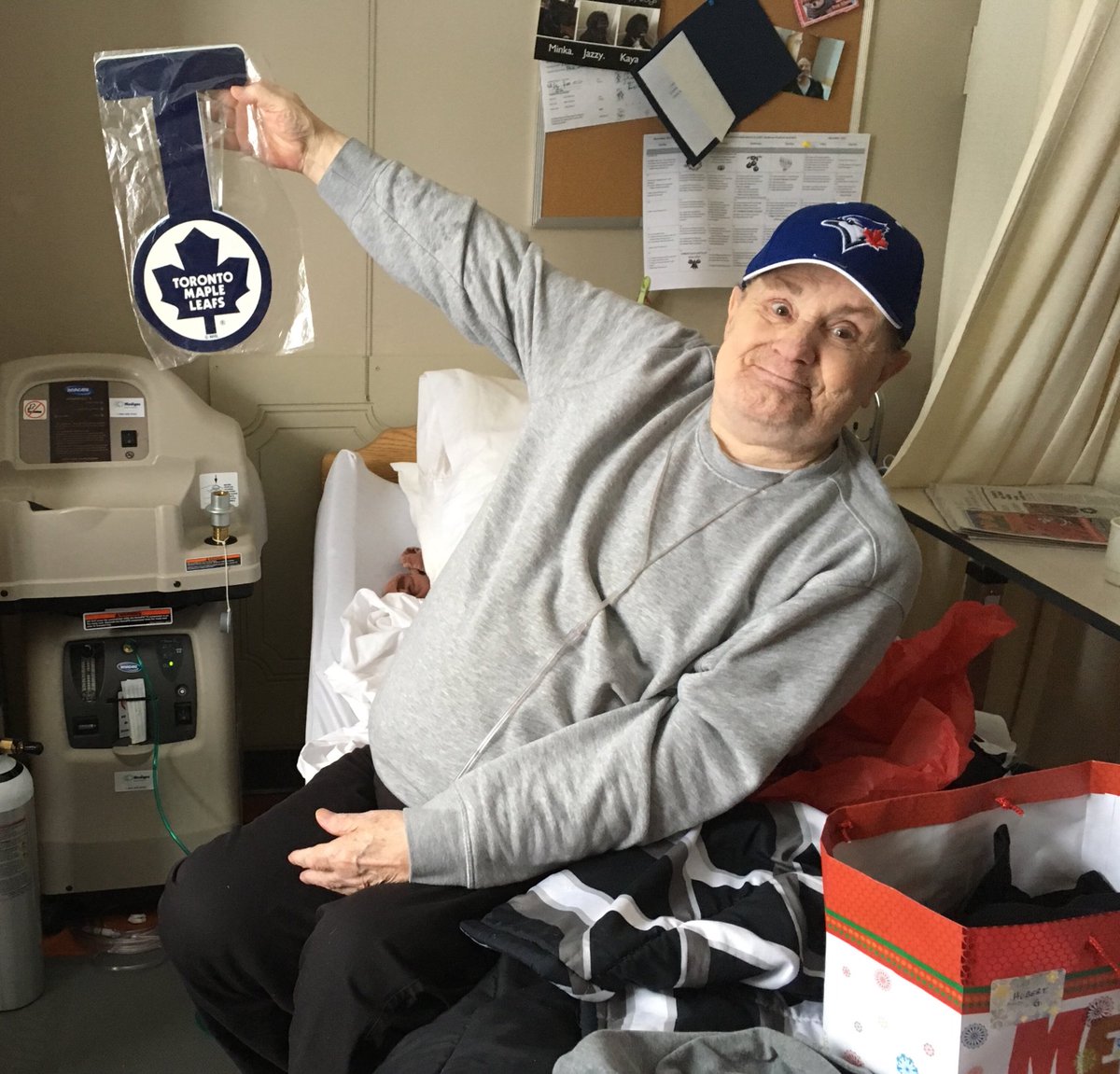 SantaToSeniors's tweet photo. We surprised Hubert in his room. He is a huge Maple Leaf & Blue Jay fan and was ecstatic about his gifts, which included a ball cap, Maple Leaf gear, shirts & treats! Thank you to his gifter for making it an extra special Christmas for him! #SantaToSeniors #ROWPS https://t.co/9eAmfDCKzQ