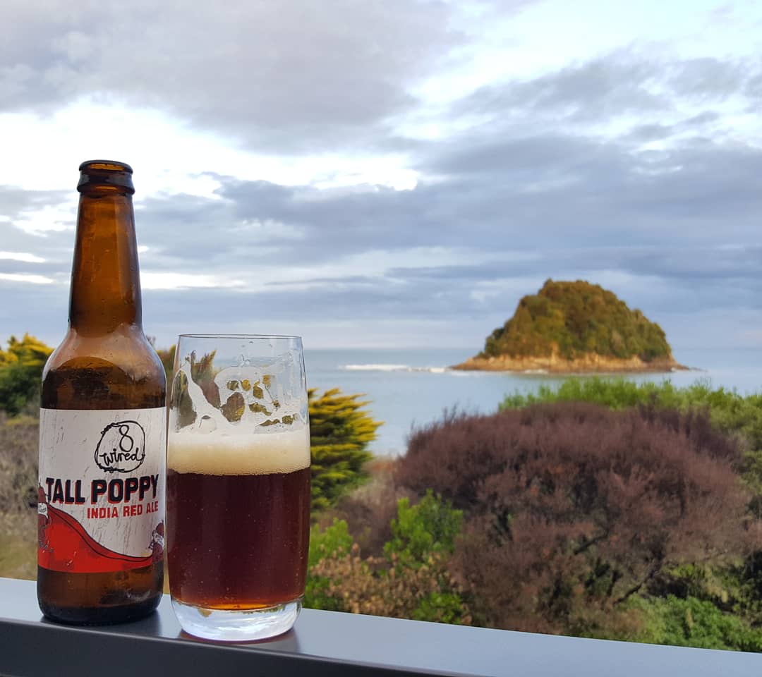 Bibliocook's tweet photo. Tall Poppy #IndiaRedAle from @8wiredbrewing at the most beautiful beach in New Zealand. #NgaioBay https://t.co/JJRbLQd8ZJ