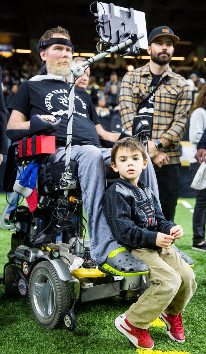 SophiaGermer's tweet image. Rivers Gleason sits with dad #SteveGleason on the sidelines before the playoff game in the #Superdome #CARvsNO @TeamGleason  @theadvocateno @WWLTV