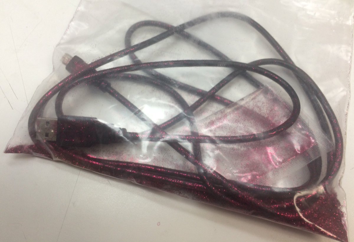 USB cable in ziplock bag with pink glitter.
