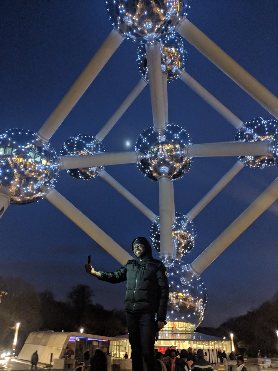 LarryMadowo's tweet photo. The Atomium is lit up beautifully at night but it’s not easy to take a picture if you look like me. So I improvised while @MichAtagana snapped away #AfricanProblemsAfricanSolutions https://t.co/p2UILOfkif