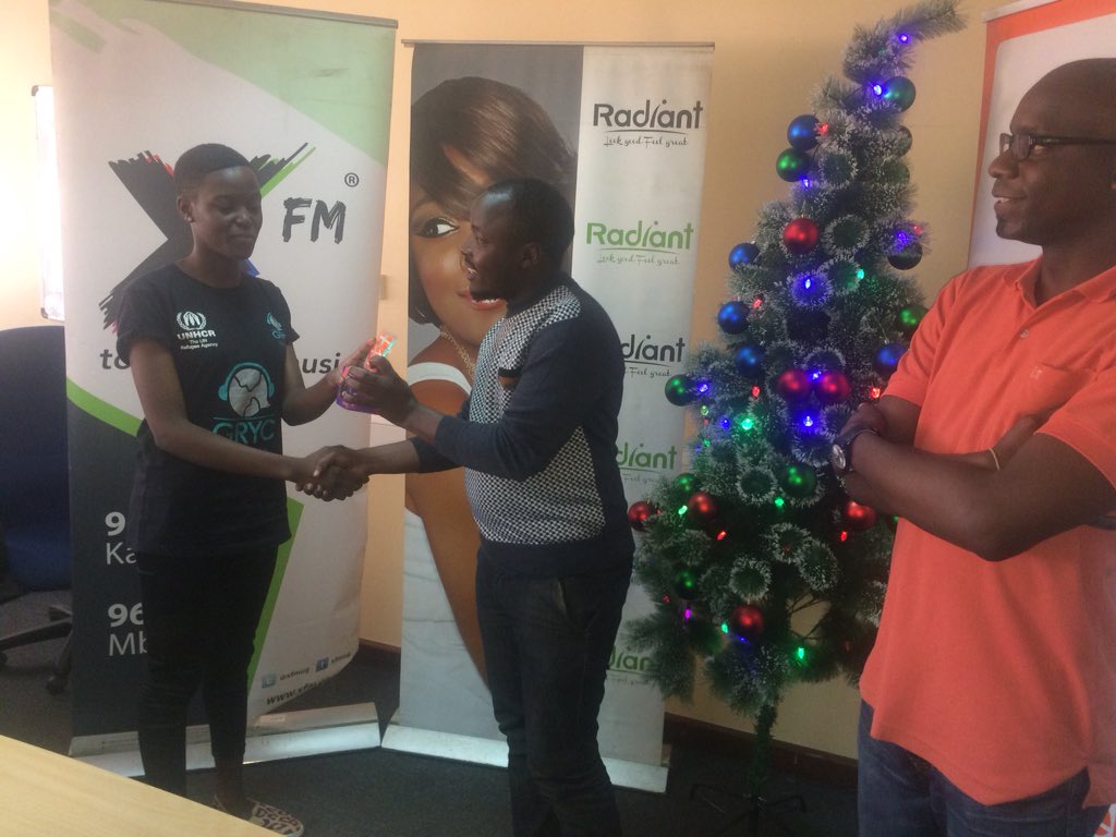 africellUG's tweet photo. Our PRO @EdgarKaramagi and Social Media Manager @oworugambo hand over prizes to #XFmLitMas winners. https://t.co/fMEc8slvSV