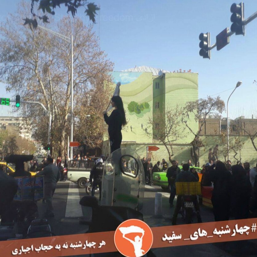 BiancaJagger's tweet photo. This Brave #IranianWoman was protesting against the compulsory hijab in #Tehran. She was arrested by the security guards. I urge President @HassanRouhani to free all the #IranianProtesters #WhiteWednesday. https://t.co/o2REG77Bzo https://t.co/ErmCWESYlp