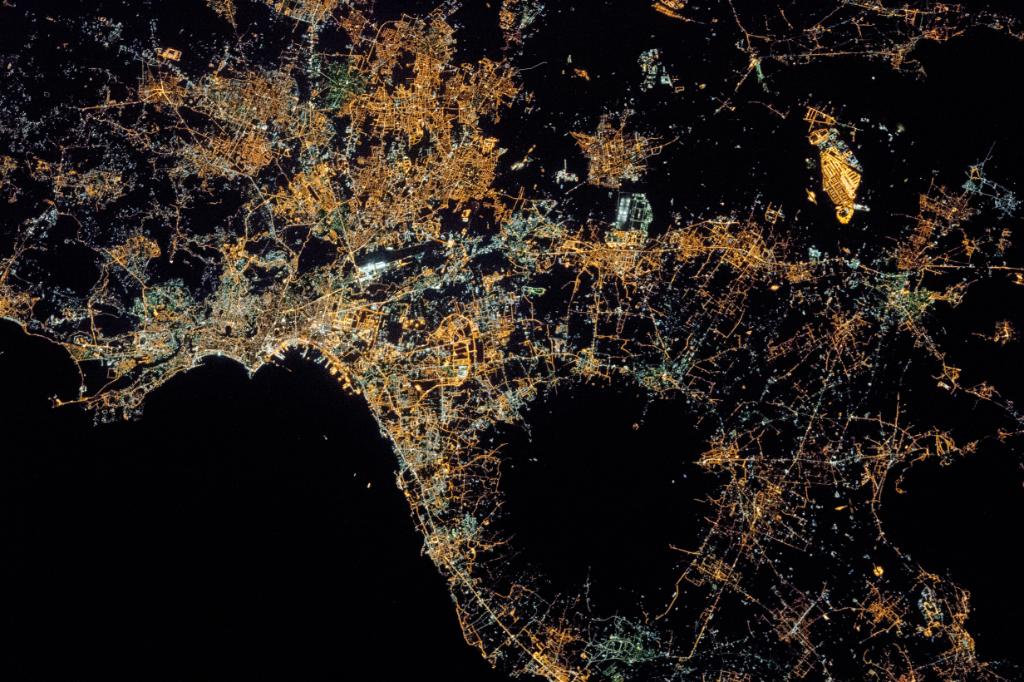 The sparkling city lights of Naples and the Campania region of southern Italy are seen from the <a href="/Space_Station/">International Space Station</a> in this nighttime pic. What’s that large black circular area? It’s Mount Vesuvius, the only active volcano on Europe’s mainland: go.nasa.gov/2CgtSmT