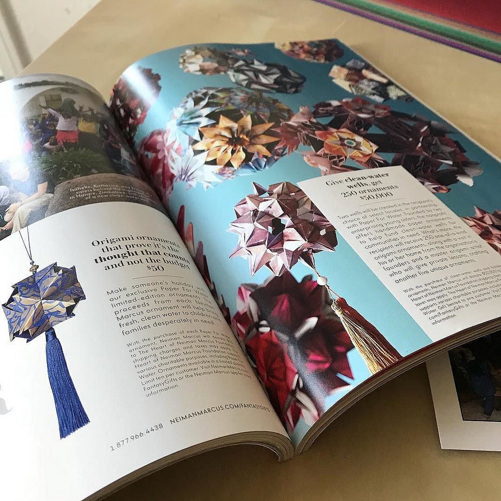 kusudamame's tweet photo. #niemanmarcus catalog with the ornaments made by #paperforwater , I finally got it :) my design #kusudamas (folded by volunteers) were sold to bring clean water to the people who lack access to it #origami #charity #paperfold #kusudama https://t.co/jVqlMBWM1x https://t.co/3Z7lq62J1Q