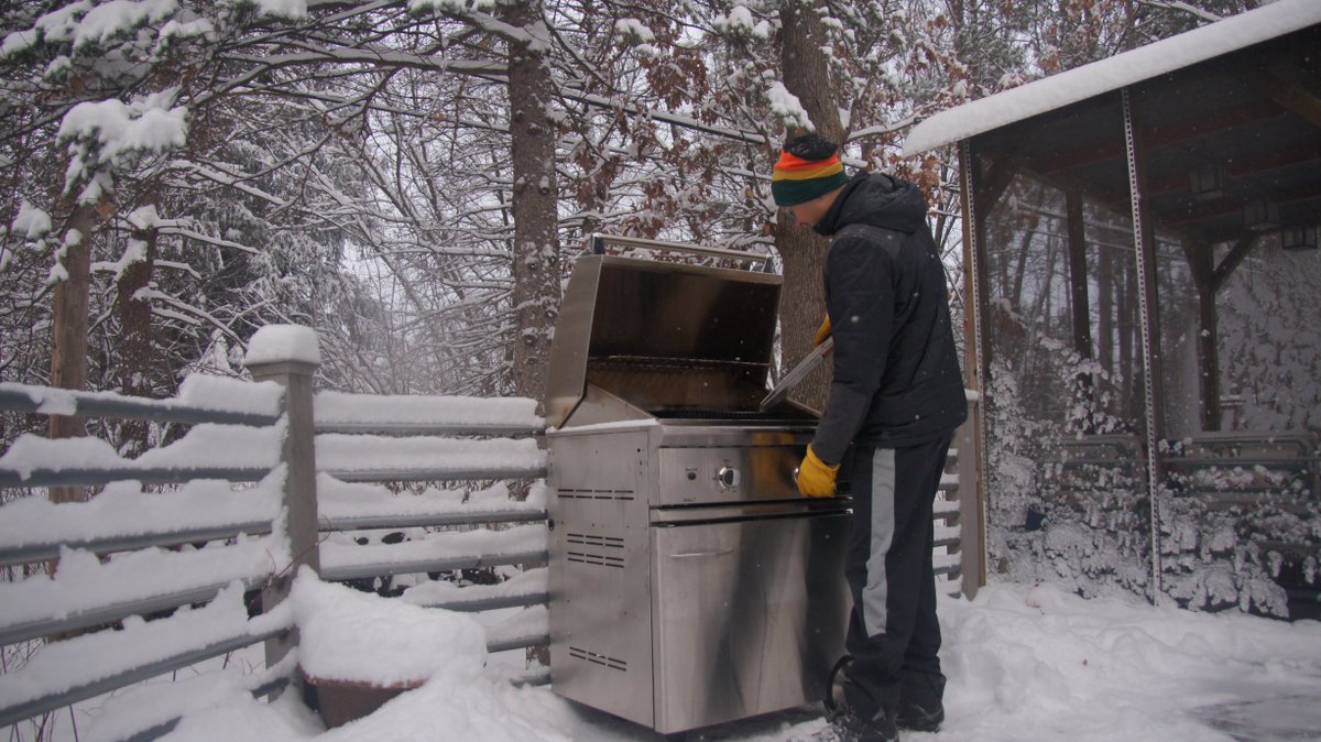 No matter the weather, nothing stands between a man and his grill.