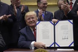 Trump's FIRST ACT of the New Year: Signs and proudly displays the "TAKING VITAL THINGS AWAY FROM PEOPLE WHO DESPERATELY NEED THEM ACT OF 2018." Aides celebrate by laughing &amp; stuffing pockets with rubles!