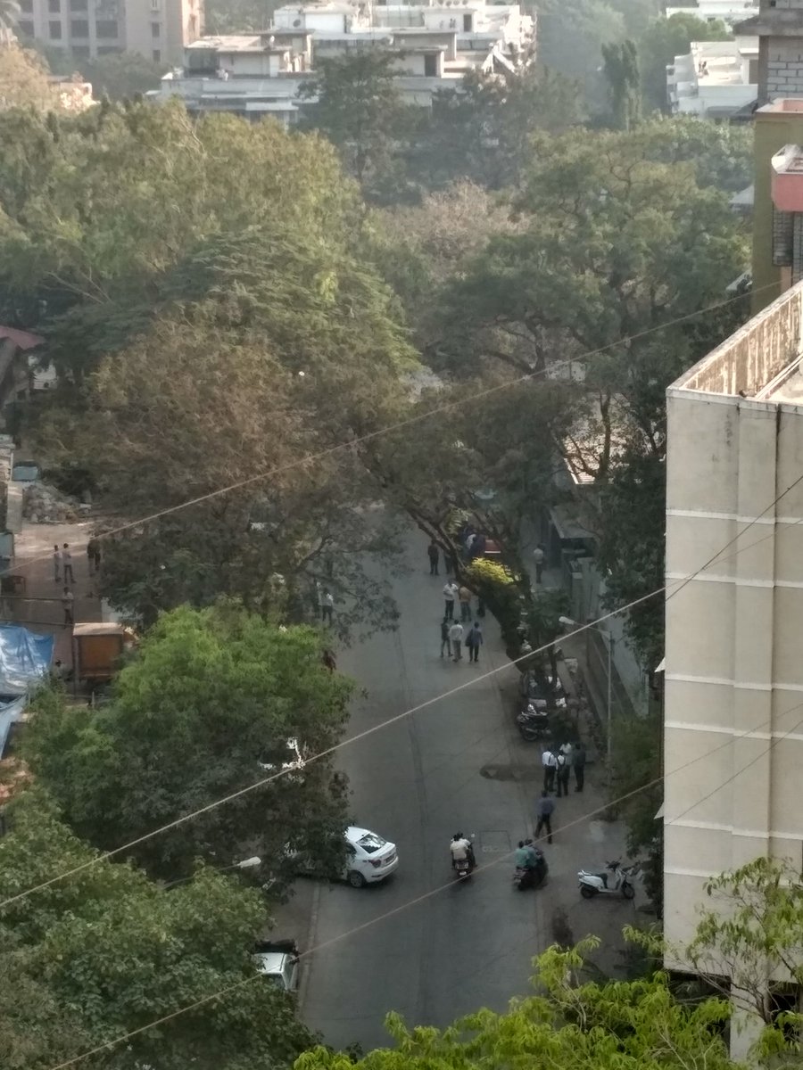 Groups of people retreating back up the street after clashes.