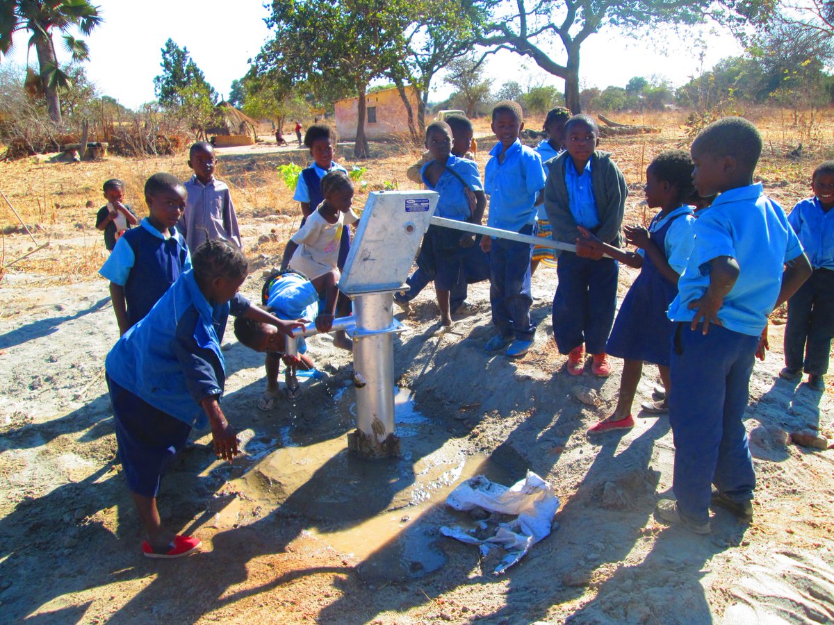 School children getting clean water at school for the first time - due to the community and HelpMercy International working together.