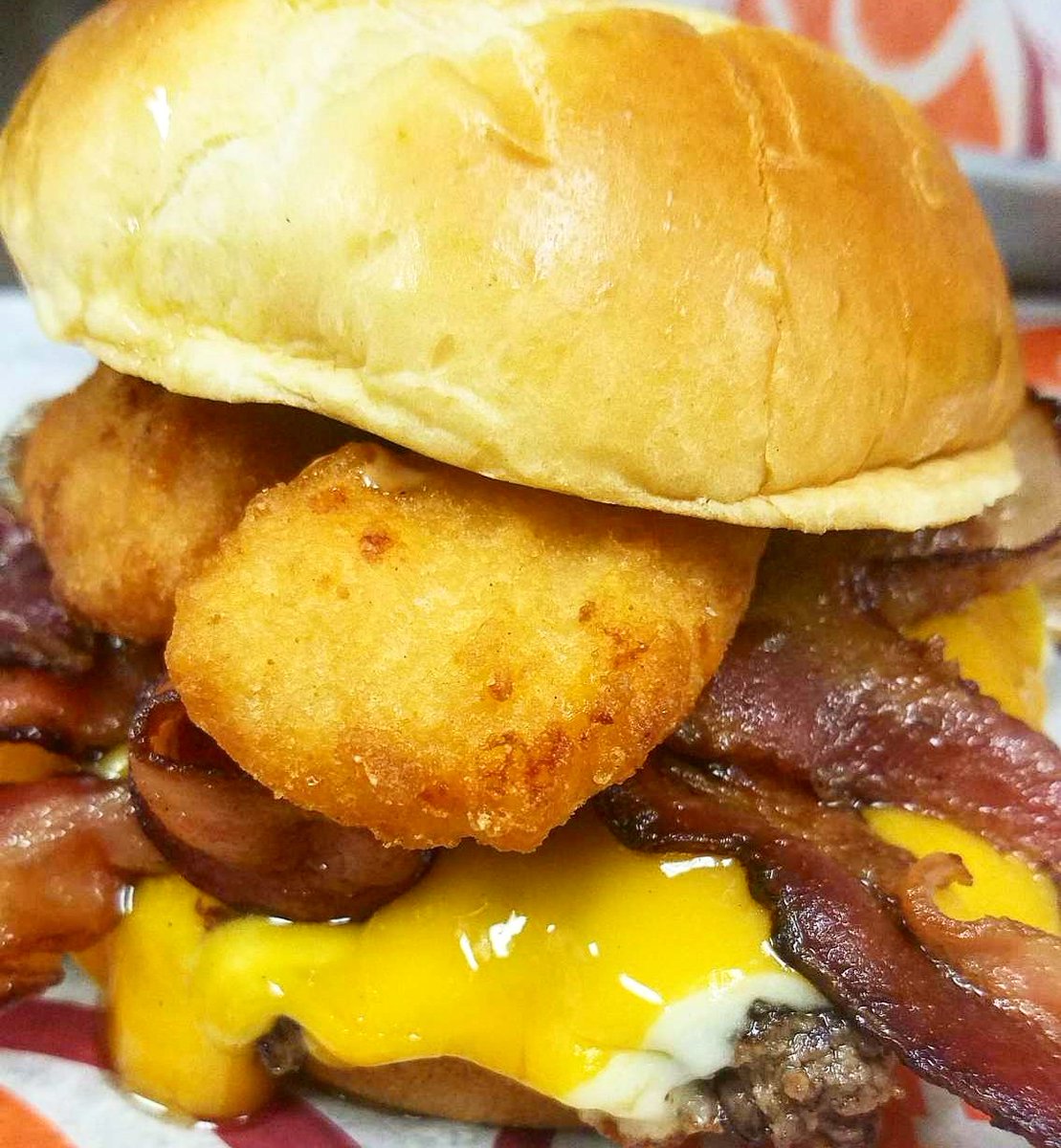 January BOM is The Resolution Destroyer! Certified Angus Beef topped with cheddar, pepper jack, 4 strips of bacon, mac &amp; cheese bites, and fusion sauce.