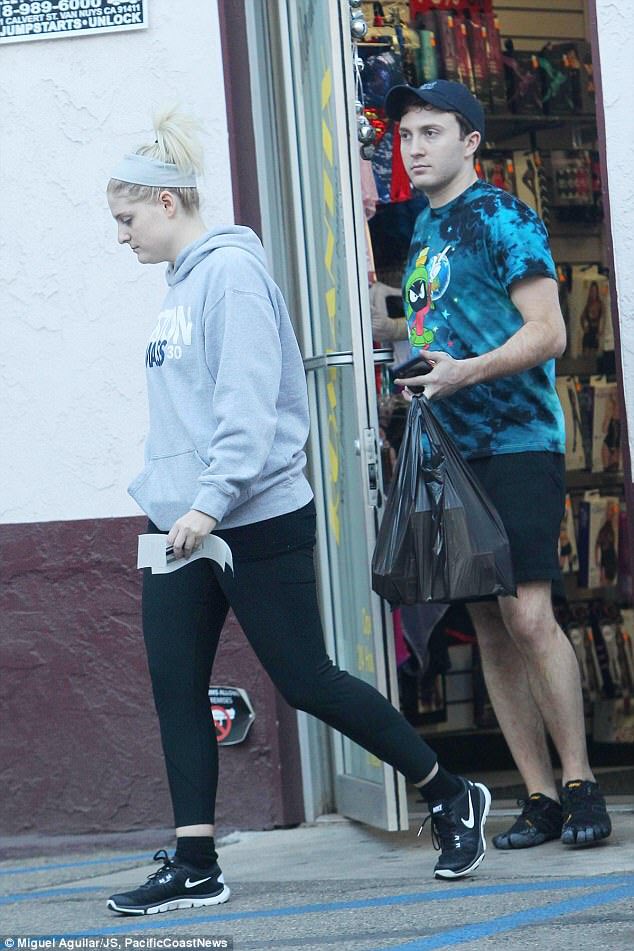 This pic of Meghan Trainor and the kid from Spy Kids leaving a sex shop with a bag of dildos is truly haunting