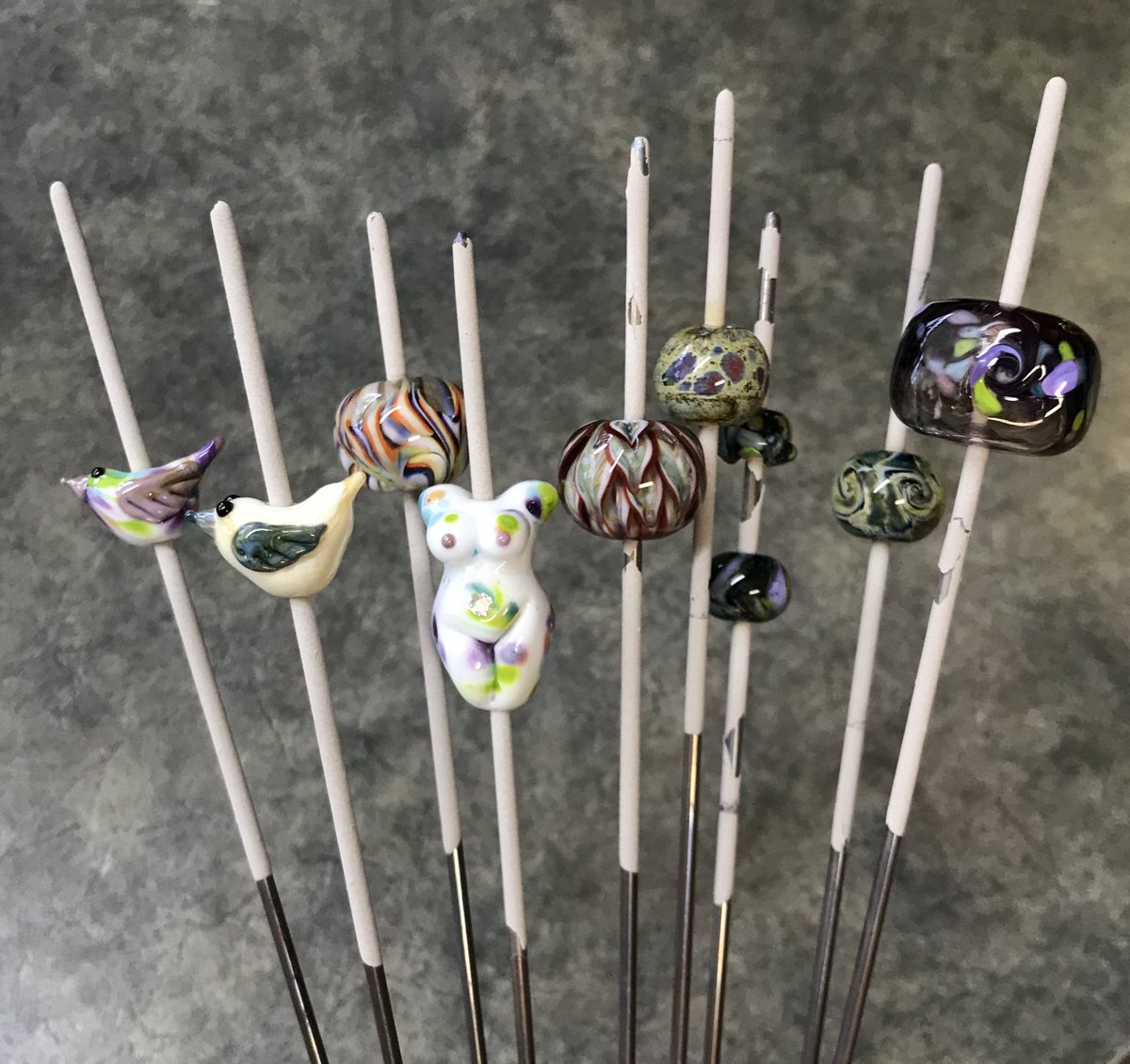 EllJay_Design's tweet photo. First group beads made on my own torch! I was able to fit more than I thought in my little kiln. Couldn’t decide what to focus on so I did a few. #elljaydesign #yqr #fireandsharpthings #soexcited #gettotrysomethingnew #lampwork https://t.co/brymeEGZON