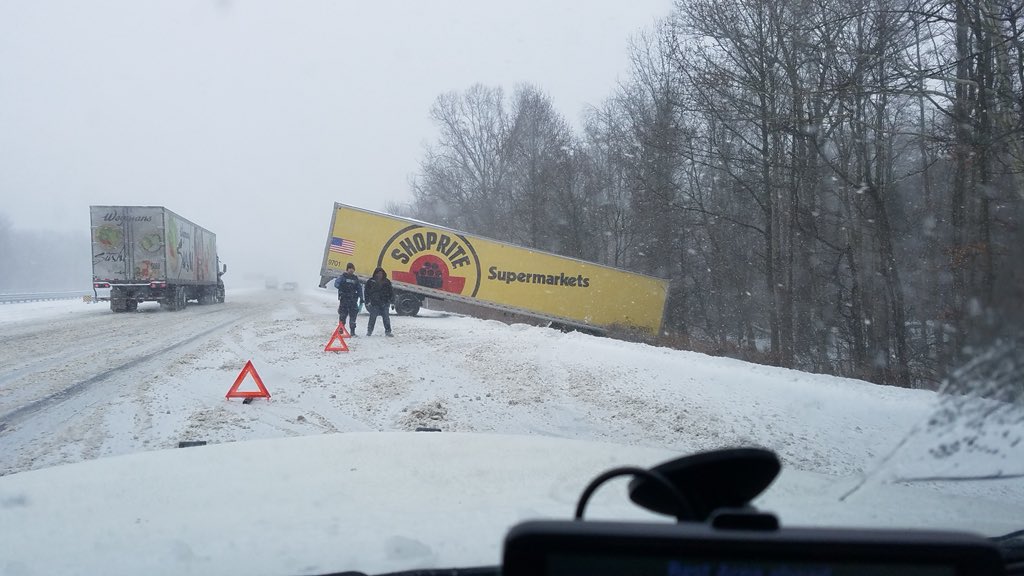 NJSP's tweet photo. Across the state the Troops are handling all types of #BombCyclone related incidents. Pictured here are Bordentown Troops dealing with a tractor-trailer stuck off of the roadway. https://t.co/kLUstSHJof