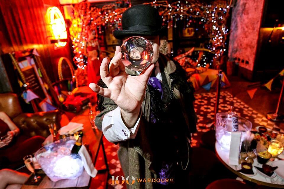 NotMyCircusUK's tweet photo. The mesmeric @PartyMystic mystifying the photographer and guests on NYE at @100WardourSt #CirqueDSoho event. https://t.co/DOXqZMBeI7 https://t.co/fkdJZmrzCq