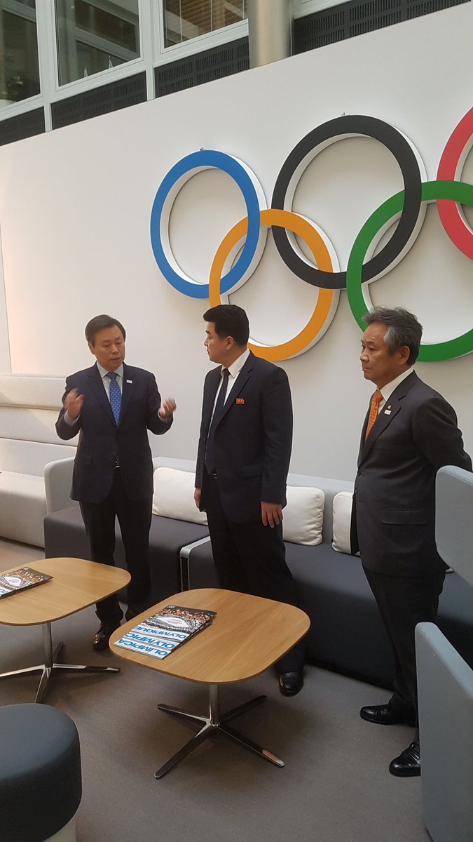 North and South Korean Sports Ministers under the Olympic Rings. Ahead of discussions on particpation in  Olympic Winter Games PyeongChang 2018