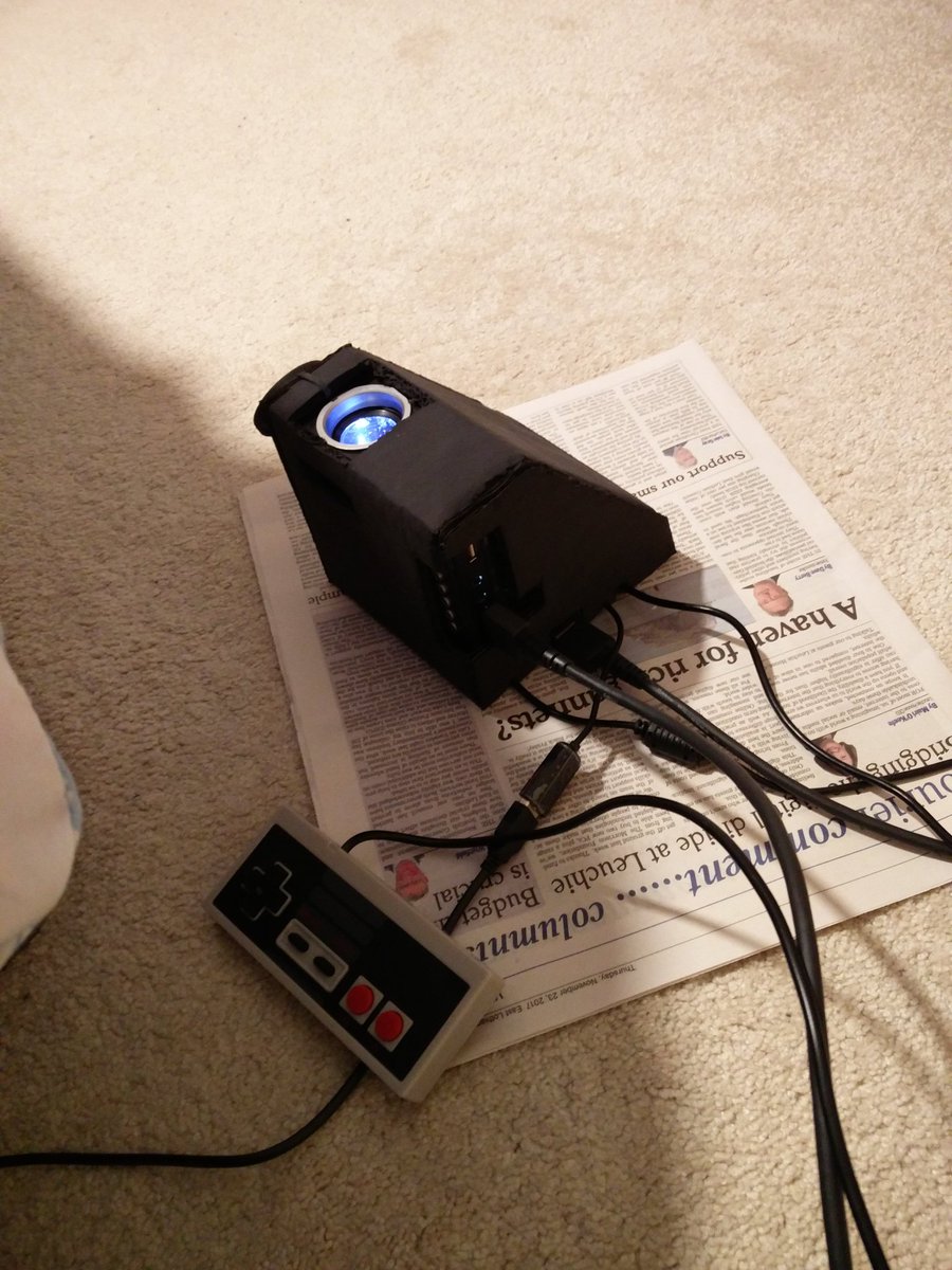 AlexDWood's tweet image. Made this Retropie-based game console with a Raspberry Pi Zero W and cheapo projector. The case is only cardboard but Nintendo just made that ok