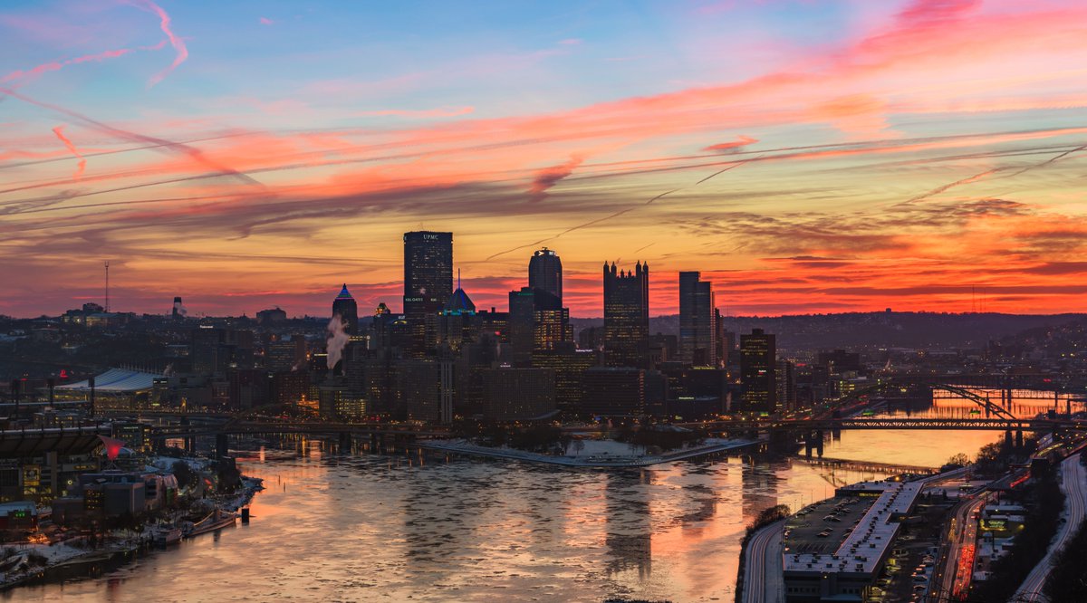 DaveDiCello's tweet photo. What a way to start a Friday: a fiery sky provides an incredible backdrop for downtown #Pittsburgh this morning as pieces of ice float down the rivers, creating a perfect natural contrast https://t.co/HggkJAQ1ev