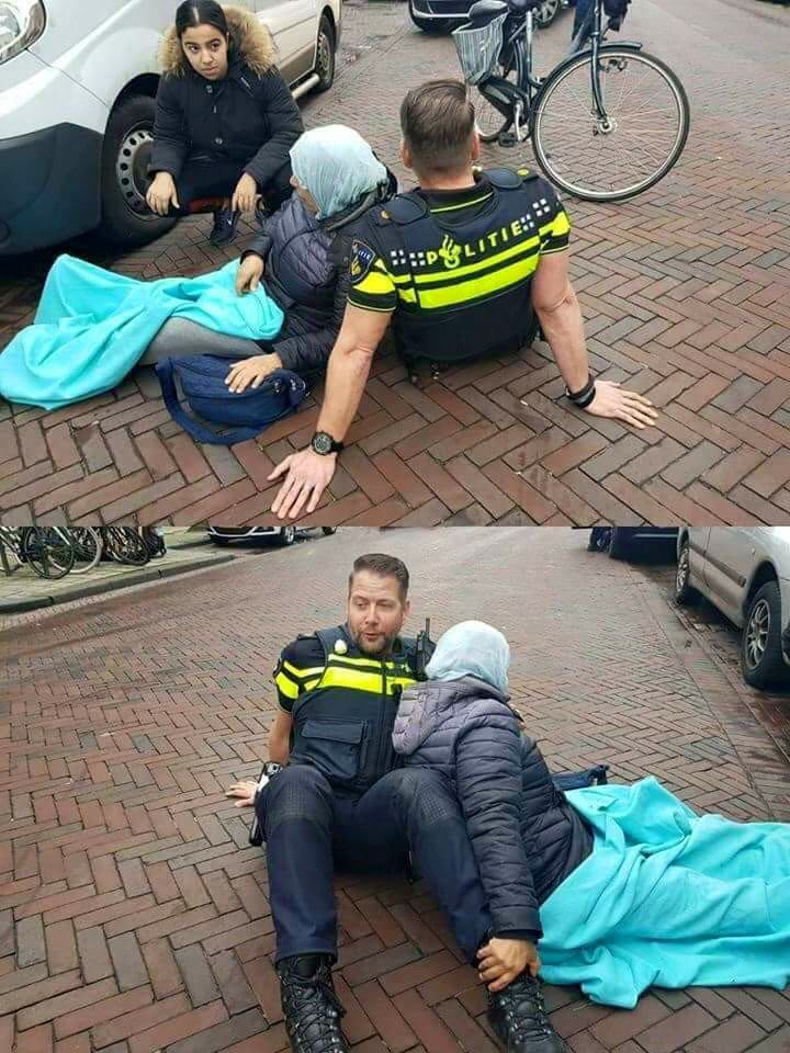 khalid22k's tweet photo. لقطة العام : 
في انتظار وصول سيارة الاسعاف .. شرطي هولندي يوفر مسند بجسمه لامرأة مسلمة أُصيبت في حادث سير ..
"لا تحدثني عن دينك .. ولكن دعني أراه في سلوكك وتعاملك مع الآخرين" .
#الدين_المعاملة https://t.co/CzakhreN5C