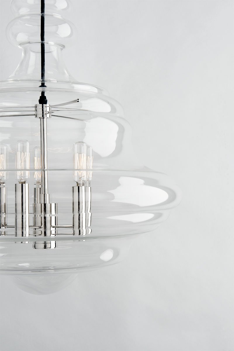 To create our Washington pendant's elegant shape, a skilled artisan works molten glass into a paste mold as an assistant carefully turns it. The team produces a seamless piece of beautifully figured glasswork. #hudsonvalleylighting