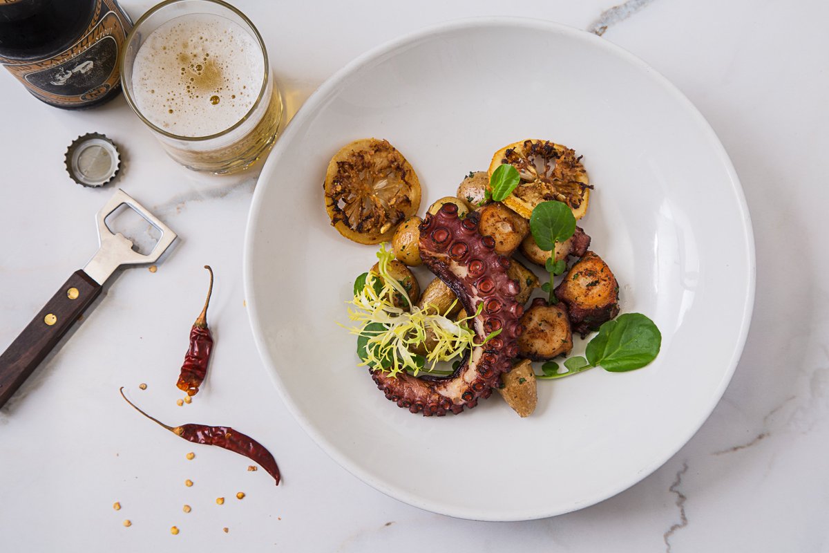 A taste of the sea: Grilled octopus served with a kick of chorizo 🐙