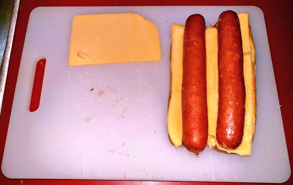 (1) Hot dogs with cheese and bottom bun.