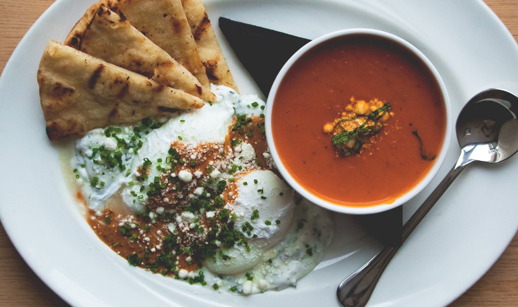 Eggs du jour: Turkish eggs with tzatziki, feta and grilled naan bread.
Soup: red pepper bisque. 
#finditdowntown #meetmeattheforks #Winnipeg
