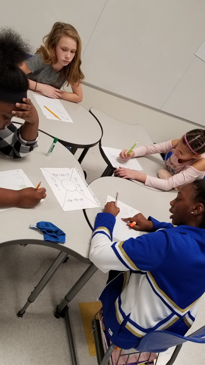 Brittchilly's tweet photo. Individuals work on one of four problems.  Individual answers are then added together and a group answer is placed in the circle.  Students work to together to ensure their group's answer is correct. #ccs_tlt https://t.co/W4Zanx1POm