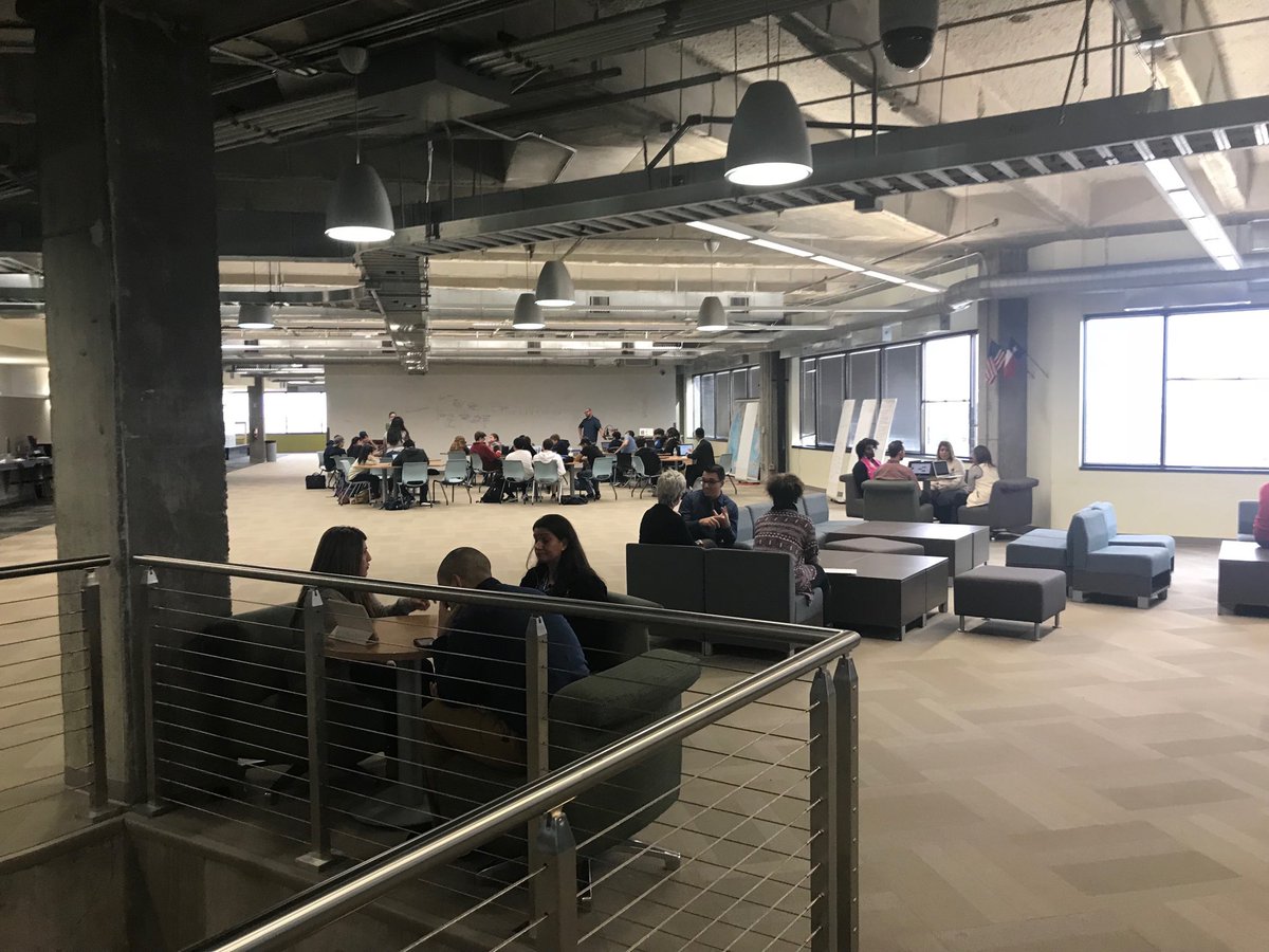 pisd_sel's tweet photo. In the foreground teacher leaders talking about their projects at the academy. Academy students learning in the background. What a tribute to the culture of learning at the academy. #pisdleads @PlanoAHS #pisdlda https://t.co/FXWWvJwpyx