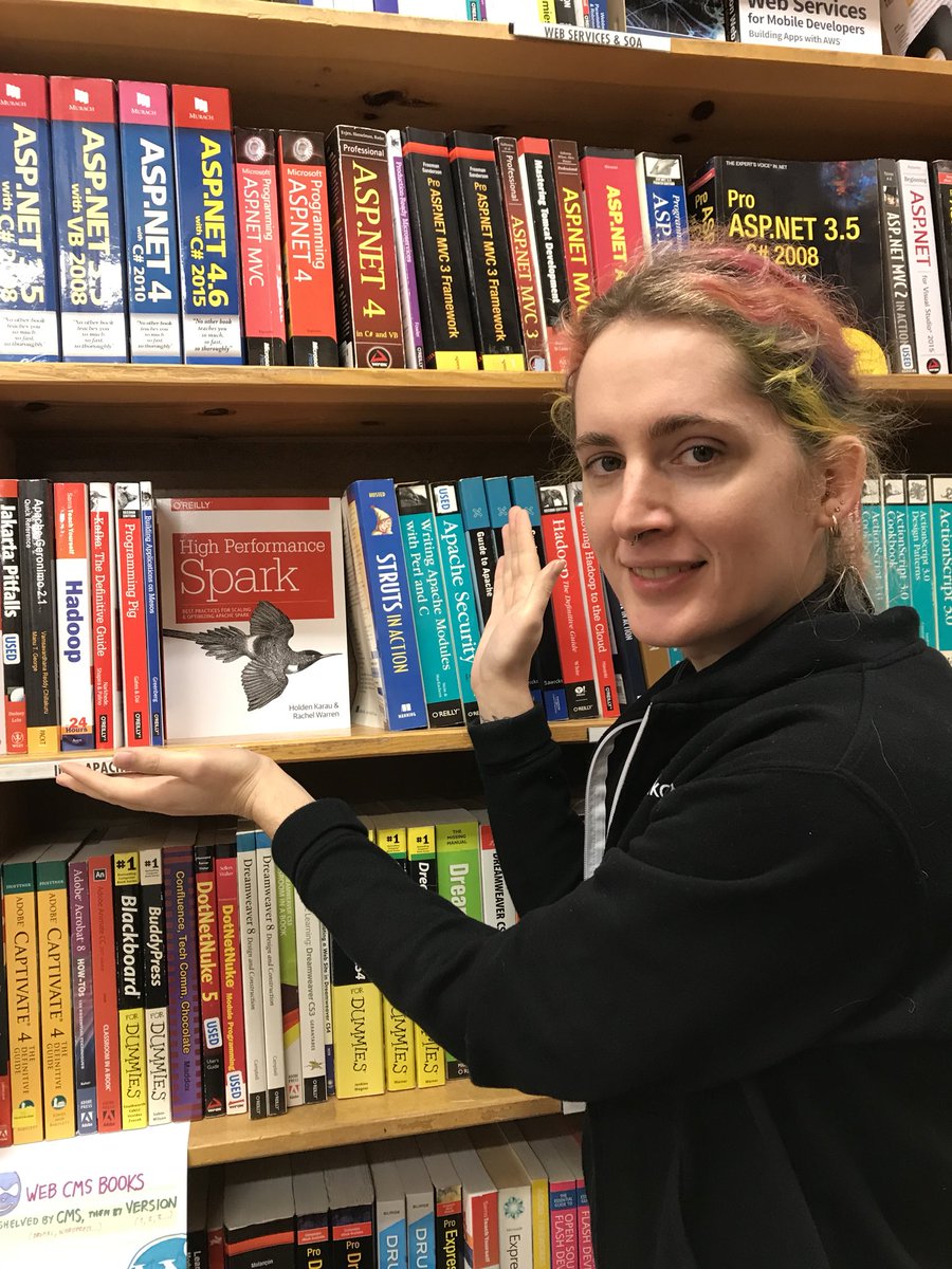 holdenkarau's tweet image. At trip to Portland isn’t complete without a trip to @Powells and this time I got to take a picture with my &amp;amp; @warre_n_peace’s book (in section 905 if you want to come buy a copy 😛) @highperfspark 😀