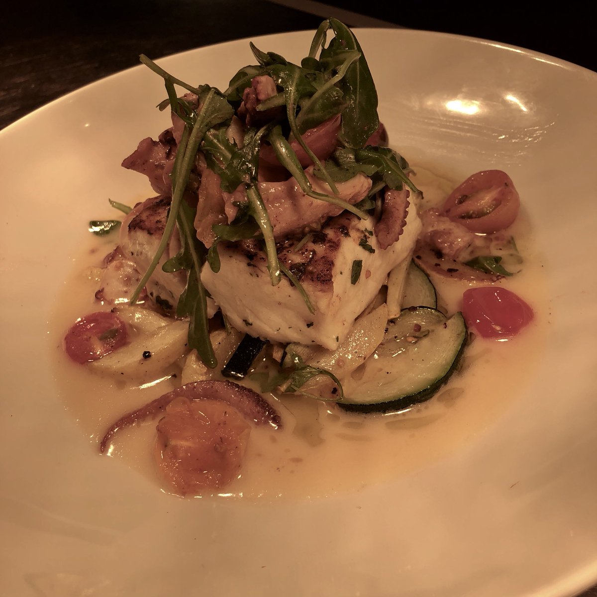 Seared halibut special tonight!!! With roasted vegetables, heirloom tomatoes, a warm octopus salad and a garlic beurre blanc!! Scrumptious!