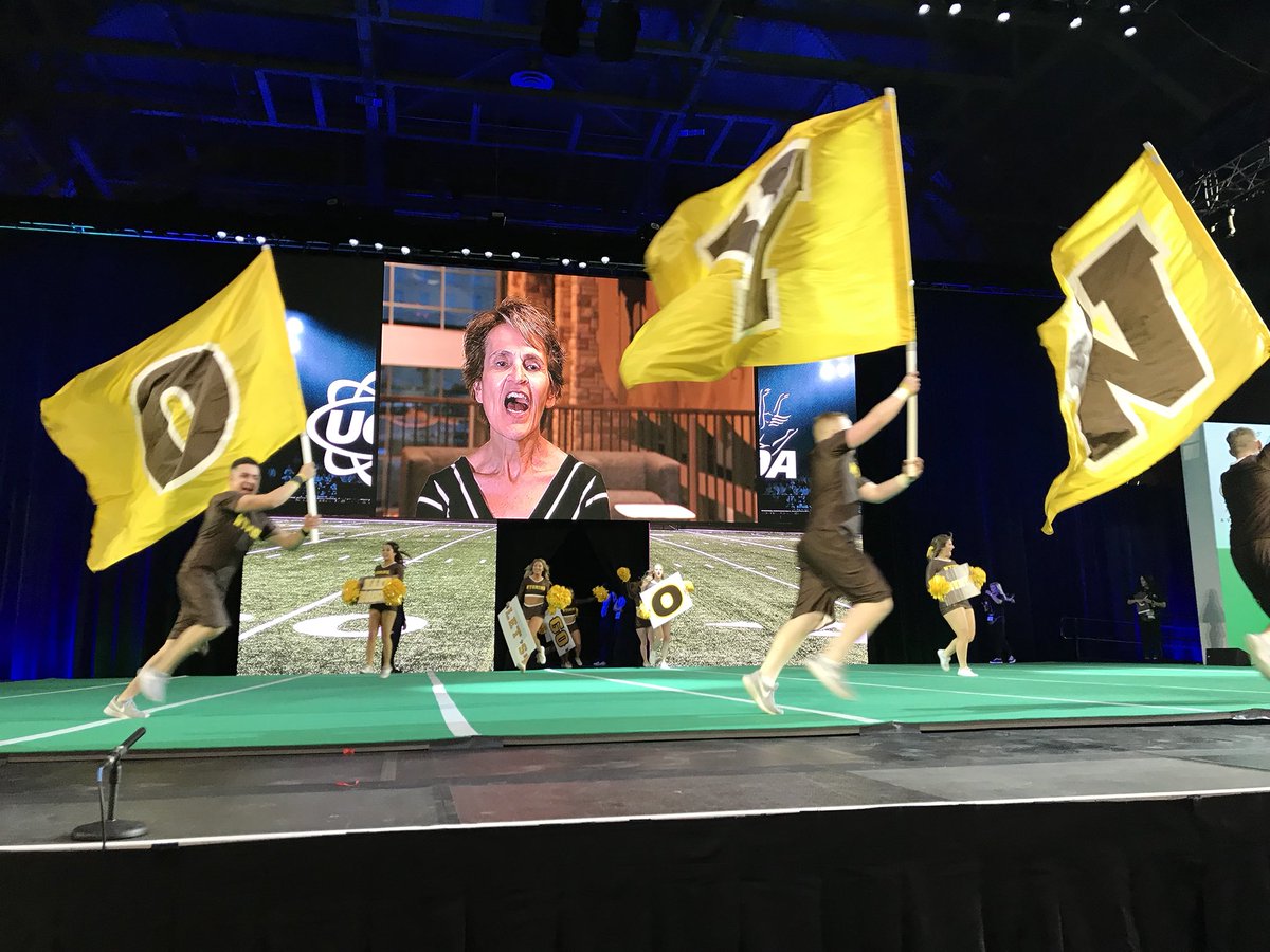 UCAupdates's tweet photo. “Where did ya come from? Let’s Go Pokes!” Wyoming Coed came out with so much energy for their Game Day performance! 💛 #UCAnationals https://t.co/N69VUZDE0g
