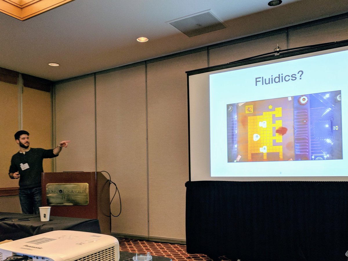 Max points at a video of a microfluidics chip moving water to mix chemicals