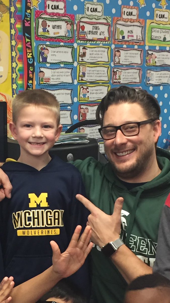 Two Michigan fans!! Mr. Beel is wearing maize and blue underneath the green!😂💙💛#mrbeelisthebest