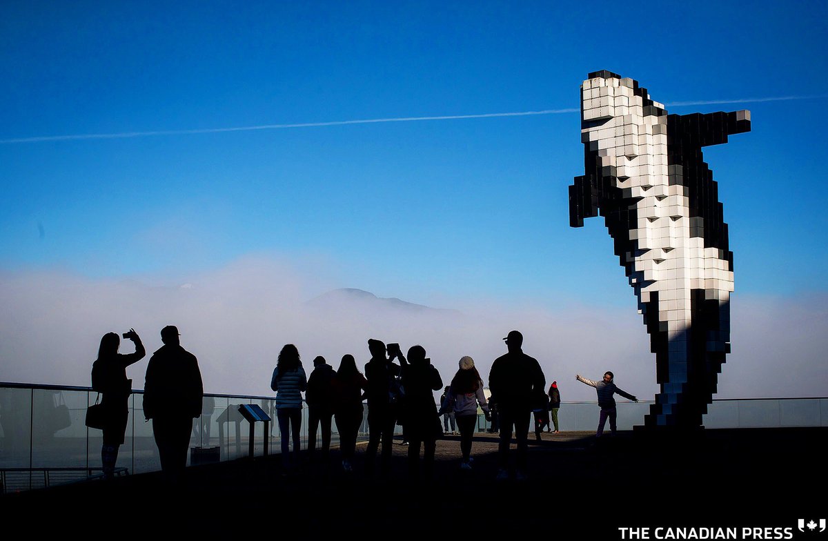 People take photographs of Douglas Coupland's "Digital Orca" sculpture as fog hangs over the harbour in Vancouver, B.C., on Sunday January 14, 2018. THE CANADIAN PRESS/Darryl Dyck <a href="/cdnpress/">cdnpress</a> #vancouver #fog #douglascoupland #orca instagram.com/p/Bd8qUtvAe52/