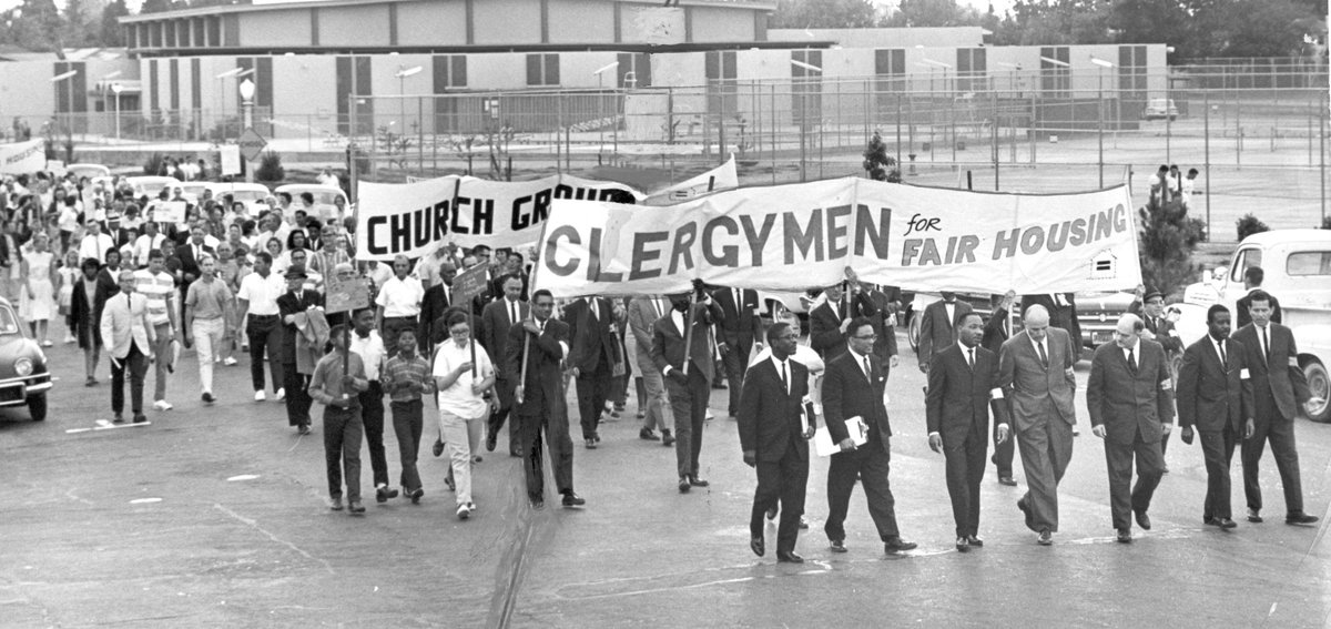 FresnoBee's tweet photo. The Rev. Martin Luther King Jr., third from left, helps lead a march toward Ratcliffe Stadium in 1964 in this Fresno Bee file photo. Today, MLK's legacy is honored with a march starting at St. John's Cathedral at 9:15 a.m. and a commemoration ceremony following at City Hall. https://t.co/ve4bwUTUWM