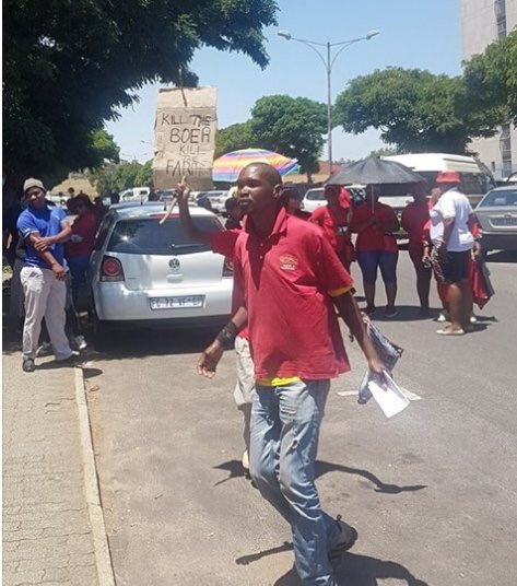 HateCrimeSA's tweet photo. “Kill the Boer Kill the farmer” poster held by an EFF supporter outside court. #TractorShooting #HateSpeech #CountryDuty https://t.co/55asDOIyfD
