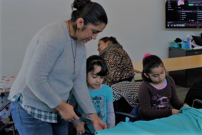 LearnComm's tweet photo. How to honor Dr. King on #MLK Day? #LearnComm South Omaha families sending #2Gen warmth with cozy blankets for local shelters. https://t.co/dy7RSK4QwY