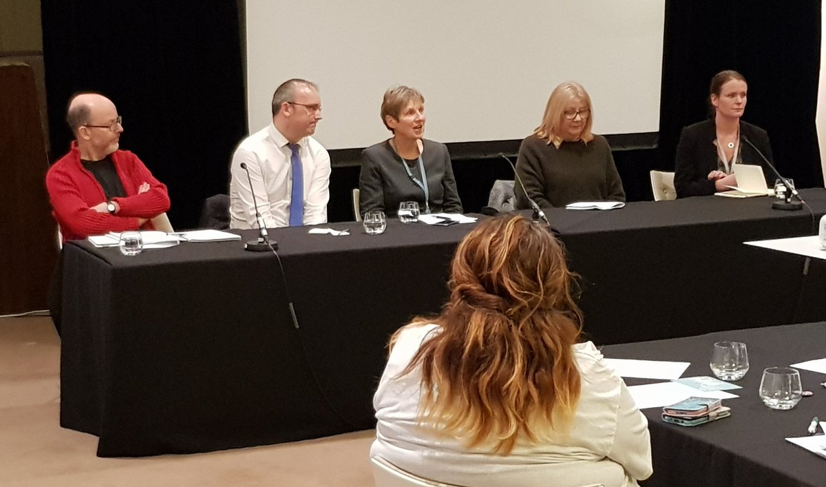 Panel table with five people sat ready to participate!