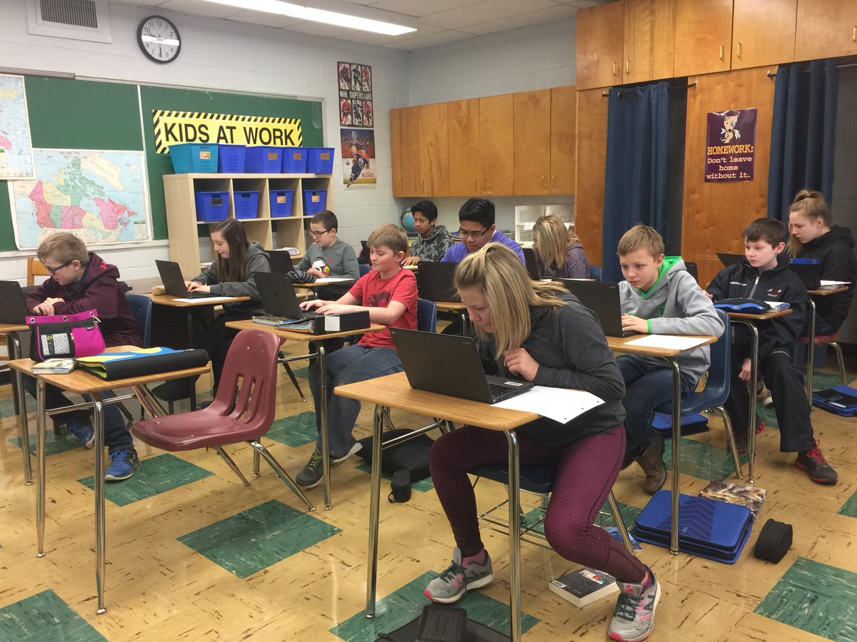 Grade 7E using the Chromebooks and Google Slides to create presentations on environmental waste.