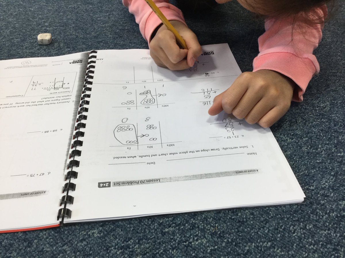 Working hard in math to make bundles of 100 when adding! Do you know how many tens make 100?