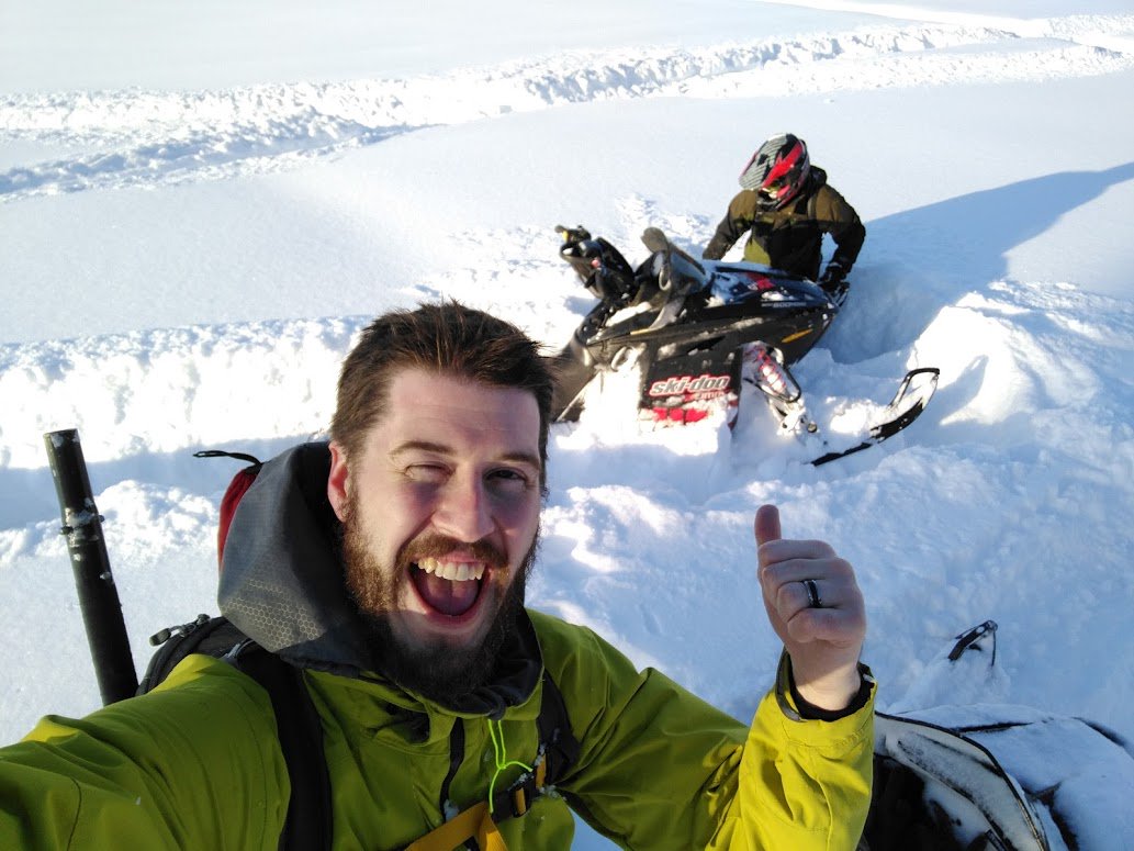 sastructural's tweet photo. There's never a dull moment when snowmobiling with Zaqueo and John in our Anchorage office! According to the guys, the hole Zaqueo is stuck in is much deeper than it looks.. and by the look of John, a laugh and photo was definitely needed for this special moment! https://t.co/lIzVAk23fJ