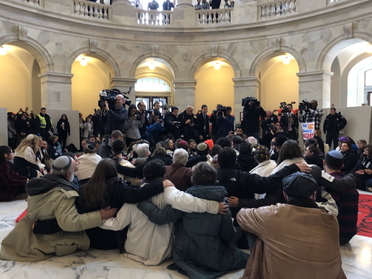 TheRAC's tweet image. Jewish activists sit and sing over warnings from Capitol Police. We will not be moved until we get a clean #DreamActNow #LetMyPeopleStay