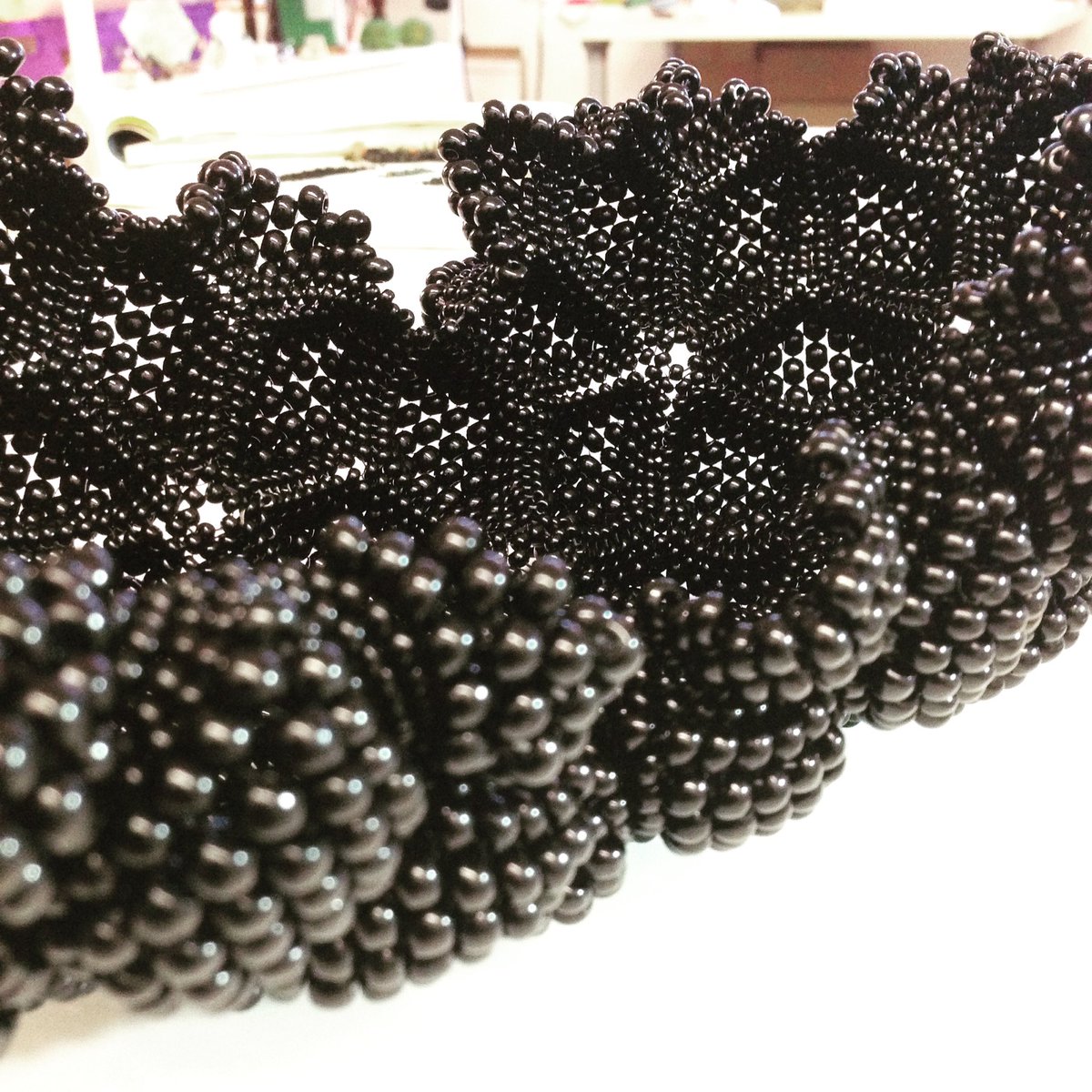 KwArtistsCoop's tweet photo. @sundropsstudio is hard at work on her latest #sculpture, what she calls 'a crazy black thing' #seedbeadart #glassbeads #makersgonnamake #HandmadeHour #beadstitching #beadweaving https://t.co/Ylctv14jal