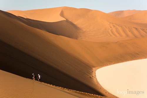 Tourists walk up the Big Daddy Dune in Sossusvlei in Namibia <a href="/Adventure_focus/">Adventure In Focus</a> More of Tom's Namibia pictures here goo.gl/vXJ4mr #Namibia #desert #wilderness #Sossusvlei