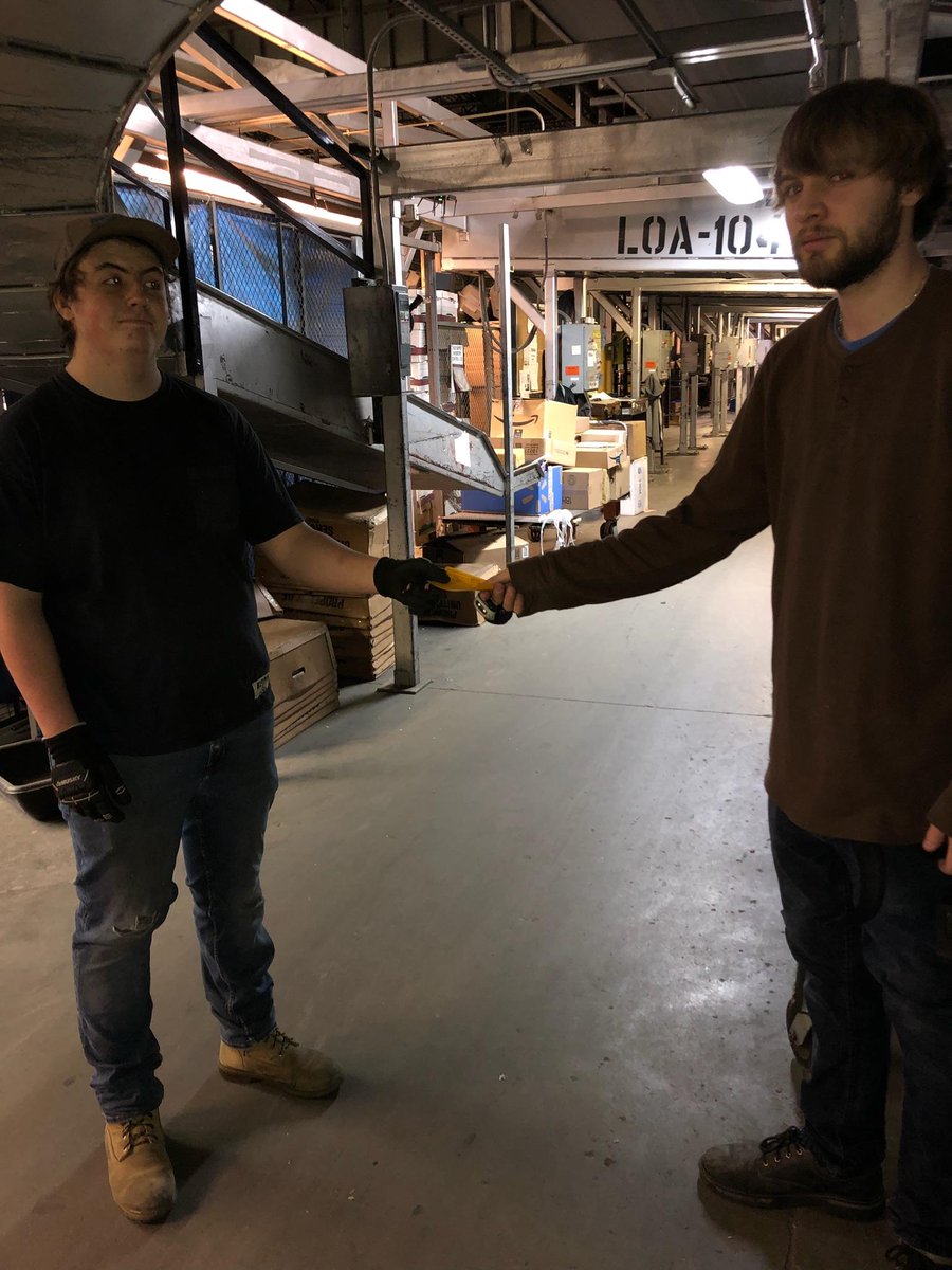 PrestonMessers1's tweet photo. Safety Rep Mitch Taylor gives a gold card to Cody Gustafson for keeping all obstructions clear off the floor and maintaining egress in his area keeping it safe for all! #CaughtSafely @UTHub_BrianW @ https://t.co/9gl7Ls3e2x