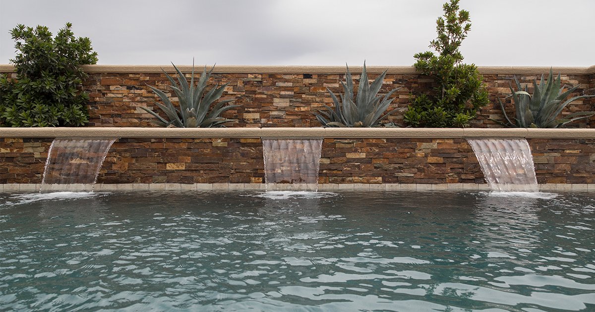 Embrace the colors and sounds of nature with Bark Ledger Stone behind a series of custom cascading waterfalls.