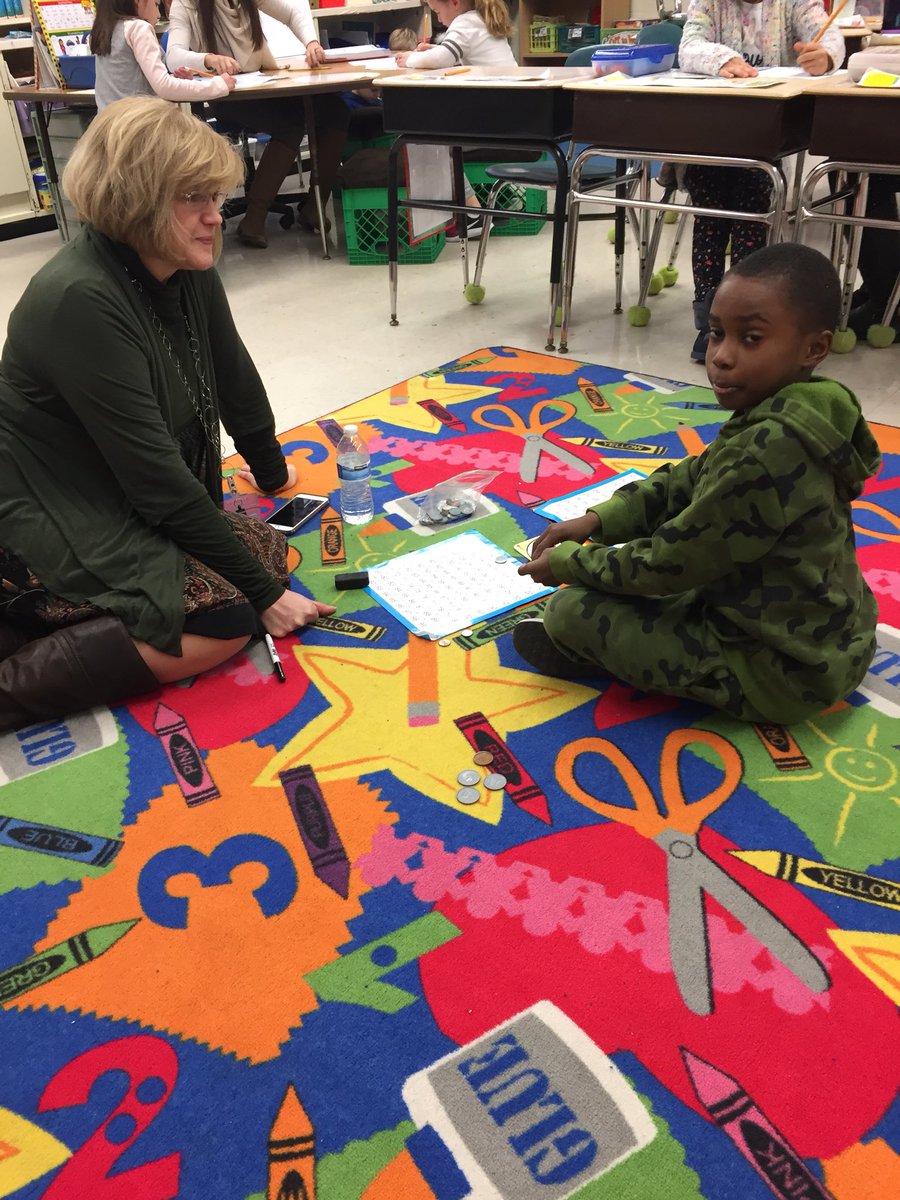 SWSelem's tweet photo. When @TammiL38 visits us, she literally gets down and does some math!  Ahmad taught her how to play a game with coins...and I’m pretty sure he won 😛 @SWSelem @Rm12withMrsE https://t.co/CkUUgJFe31