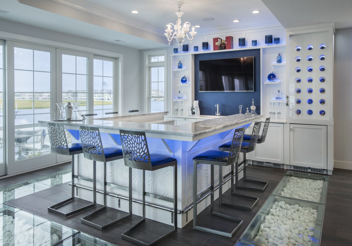 PerkinDesign's tweet photo. This unique home bar has ultra-modern touches from top to bottom -- from an illuminated stone top to an elegant glass floor. #njinteriordesign #phillyinteriordesign #interiordesign #perkindesigninteriors https://t.co/FEWRpvvPDk