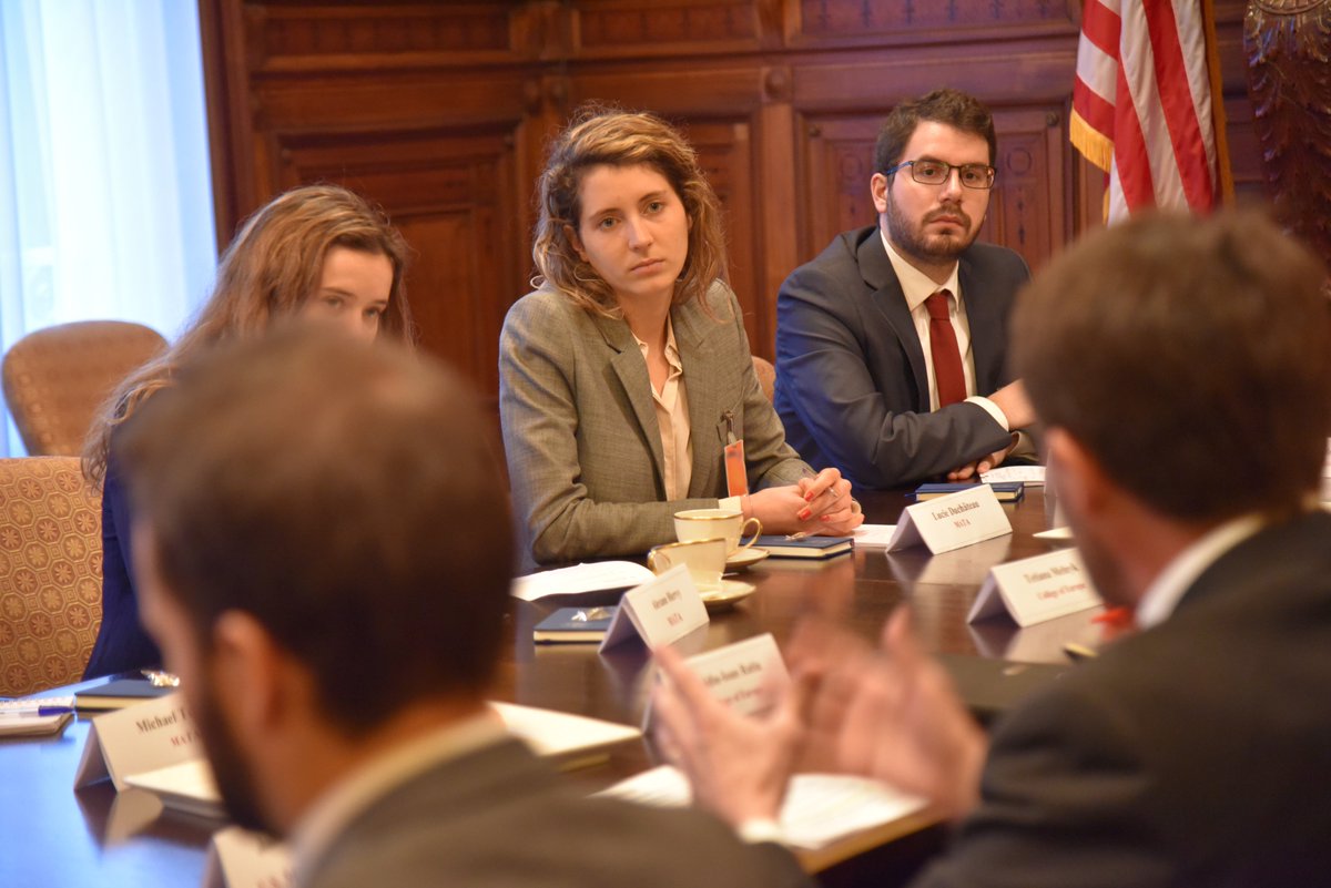 A student in the College of Europe and Fletcher School's Master in Transatlantic Affairs program listens to an USEU officer at a briefing at the US Mission to the EU.
